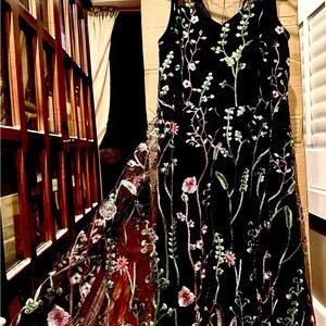 Black dress with sheer flower embossed covering.